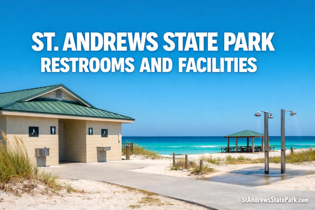St. Andrews State Park restrooms and facilities are shown near the sandy beach with clear blue water in the background.