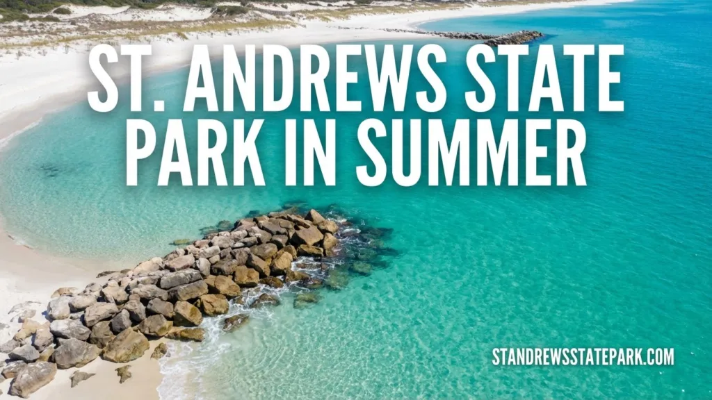 St. Andrews State Park in summer showcases turquoise water and a rocky shoreline on a sunny day.