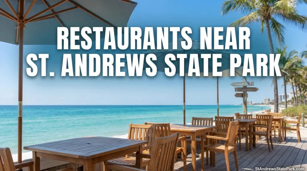 A wooden table with chairs overlooking the beach at St. Andrews State Park, near restaurants nearby.
